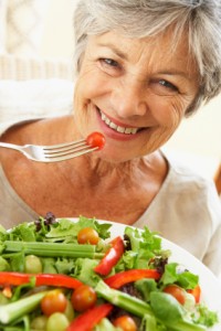 Smiling Woman Eating Salad