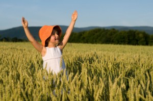 Child Frolicking in Wheat Field